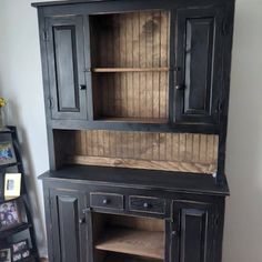 a black hutch with wooden shelves and drawers