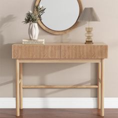 a wooden table with a mirror and lamp on it