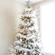 a white christmas tree with snow on it