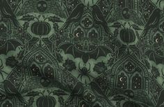 an image of a green and black fabric with bats, pumpkins and stars on it