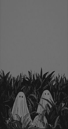 black and white photograph of two ghost heads in the bushes