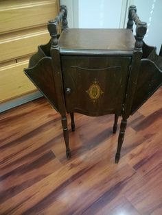 an old wooden table with two legs and a drawer on the top is sitting on a hard wood floor