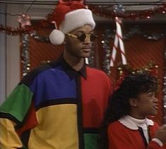 the young man and woman are dressed up in christmas attire, standing next to each other