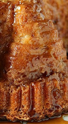 a piece of cake with caramel sauce on it sitting on a white and brown plate