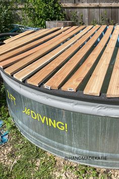 Cedar planks are laid across a stock tank and trimmed to fit the circular tank. Stock Tank Pool Cover Ideas, Poly Stock Tank Pool Ideas, Stock Tank Pools, 10ft Pool