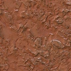 a close up view of the surface of a wall with some brown paint on it