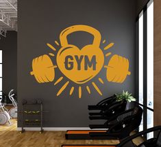 gym wall decal with dumbs and the word gym written in large yellow letters