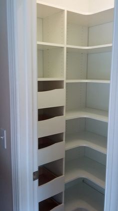 an empty white pantry with shelves in it