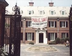 an old building with a sign that says public sale on it's front door