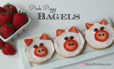 some strawberries are in the shape of pigs on top of bagels with icing