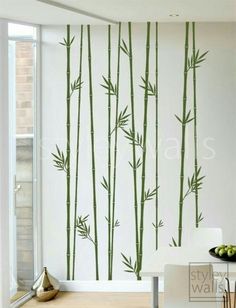 the wallpaper is decorated with green bamboos and has a white table in front of it