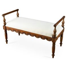 a wooden bench with a white cushion on it