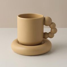 a coffee cup and saucer sitting on a table