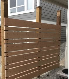 a wooden fence in front of a house