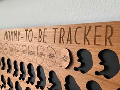 a wooden sign that says mommy - to - be trackerr on the side of a wall