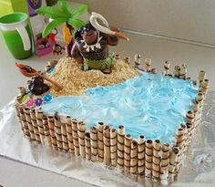 a cake made to look like an island with sand and water in it, including a man holding a baseball bat