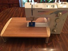 a sewing machine sitting on top of a wooden table