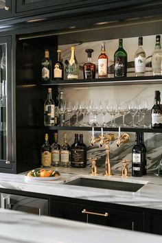 the bar is stocked with bottles and glasses