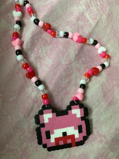 a pink and black pacman beaded necklace