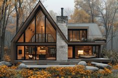 a house in the woods with lots of windows and plants on the ground near it