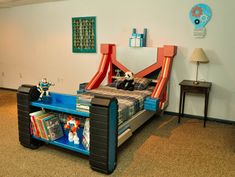 a child's room with a bed, book shelf and toys on the floor