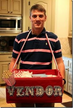 a man holding a red and white vendor bag