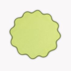 a green place mat with a circular shape on the top and bottom, set against a white background