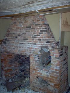 an old brick fireplace in the corner of a room that has been torn off and is being remodeled