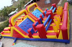 an inflatable bounce castle with slide and blow up pool for kids to play on