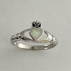 Sterling Silver Opal Heart Claddagh Ring. Heart Ring, White Opal Ring, Silver Ring, Irish Ring, Boho Ring, Friendship Ring, Can Be Worn Multiple Fingers, Midi Ring, Toe Ring. A Claddagh Ring Comprises Three Symbolic Elements, And Each Has Its Own Meaning A Crowned Heart Held By Two Hands - Symbolically, The Heart Represents Love, The Crown Denotes Loyalty, And The Hands Are A Sign Of Friendship Perfect Gift Idea For Any Occasion: Birthday, Anniversary, Engagement, Graduation, Bridesmaid, Mother’ Meaning Of Claddagh Ring, Claddaugh Engagement Rings, Irish Friendship Ring, Irish Cladaggah Ring, Irish Claddagh Wedding Rings, Cladaggah Ring, White Sterling Silver Heart Ring With Birthstone, White Heart-shaped Birthstone Ring, White Heart Cut Ring With Birthstone