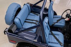 the interior of a golf cart with blue leather seats