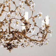 a chandelier with candles and flowers on it