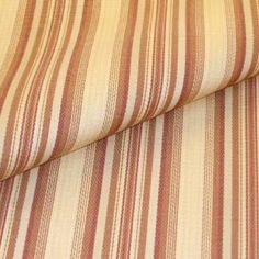 an orange and white striped upholstered fabric with red stripes on the bottom half of it