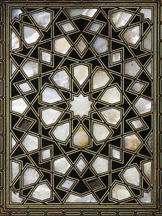 an intricately designed glass window in the shape of a star, with white and gold accents