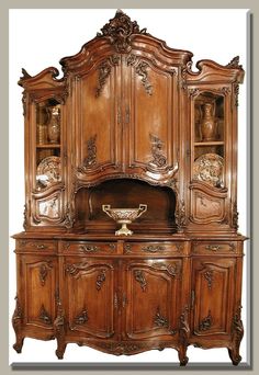 an old fashioned wooden cabinet with glass doors