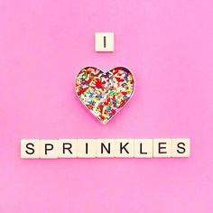 i love sprinkles spelled with letters on pink background