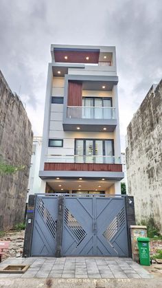 an apartment building with two balconies on the top floor and one story above it