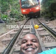 a man is taking a selfie on the train tracks