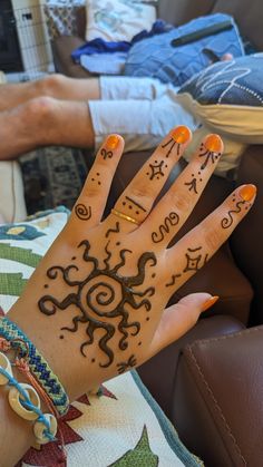 a woman's hand with henna tattoos on it