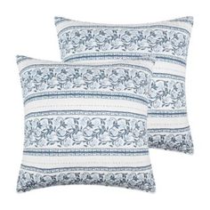 two blue and white pillows on a white background