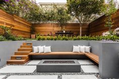 a wooden bench sitting on top of a stone patio