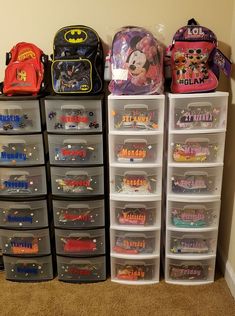 several plastic storage bins with mickey mouse stickers on them and various other items