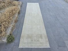 a white rug sitting on top of a sidewalk