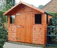 a wooden shed with the words click here to learn more about garden shed plans