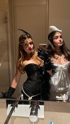 two women dressed up in costumes taking a selfie