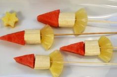 three candy sticks with pineapples and bananas on them