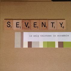 scrabbled wooden blocks spelling the word seventy on top of a brown card