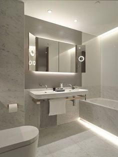 a white bathroom with two sinks and a bathtub