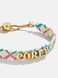 Our Criss Cross Custom Woven Friendship Bracelet offers an updated take on the ever-loved friendship bracelet trend. Colorful woven thread creates a criss cross patterned backdrop for graphic gold letter beads. Each letter is sewn on by hand for this bracelet. Pick up one for you and a friend, then choose to add your name, initials, or a favorite phrase. See our Letter Key for all options available. Please note: due to their handmade nature, each bracelet will be slightly unique. Name Necklace For Kids, Bday Gifts For Bf, 2024 Christmas Gift Trends, Best Friends Christmas Gifts, Grad Gifts For Best Friends, Cute Birthday Gifts For Best Friend, Adult Friendship Bracelets, Pickleball Bracelet, Bauble Bar Bracelet