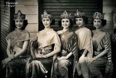 an old black and white photo of women wearing crowns